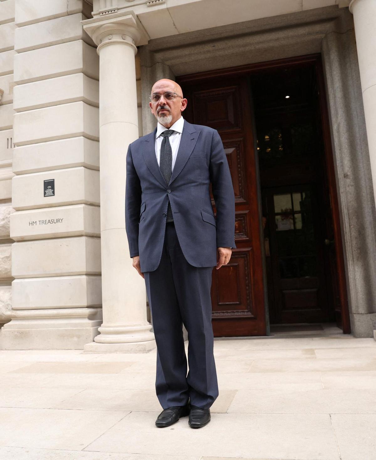 British new Chancellor of the Exchequer Nadhim Zahawi stands near Treasury building, in London