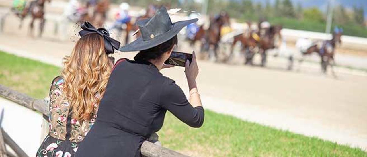 Dos de las asistentes, con sus tocados para el evento, disfrutando de una de las pruebas.