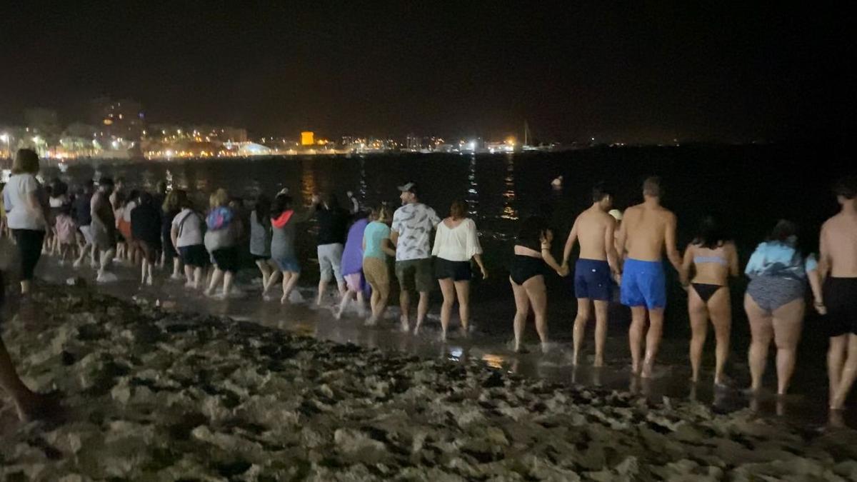 Casi dos kilómetros de cadena humana para saltar las olas de la Noche de San Juan en El Campello