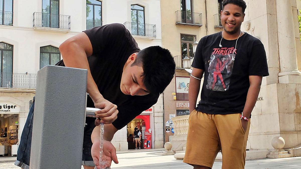 Dos nois es refresquen en una de les fonts instal·lades ahir per l’Ajuntament de  Figueres. | CONXI MOLONS