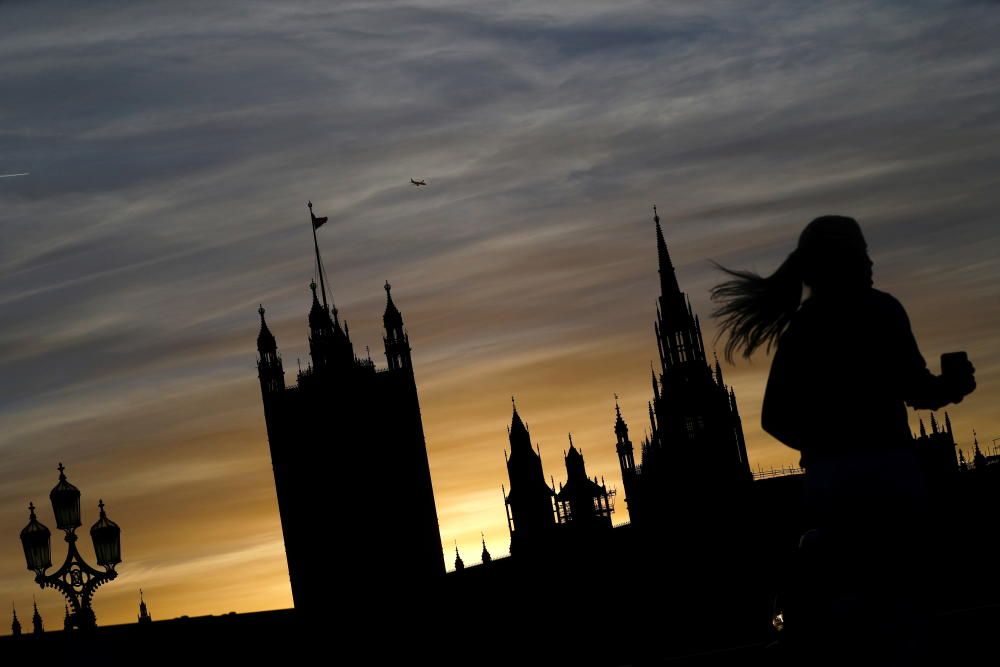 A person jogs as The Houses of Parliament is ...