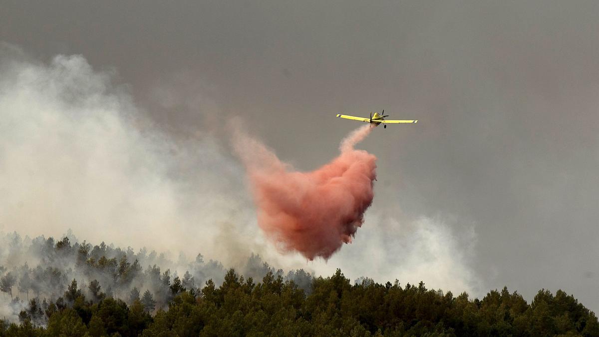 Medios aéreos tiran agua en las labores de extinción de un incendio forestal en imagen de archivo.