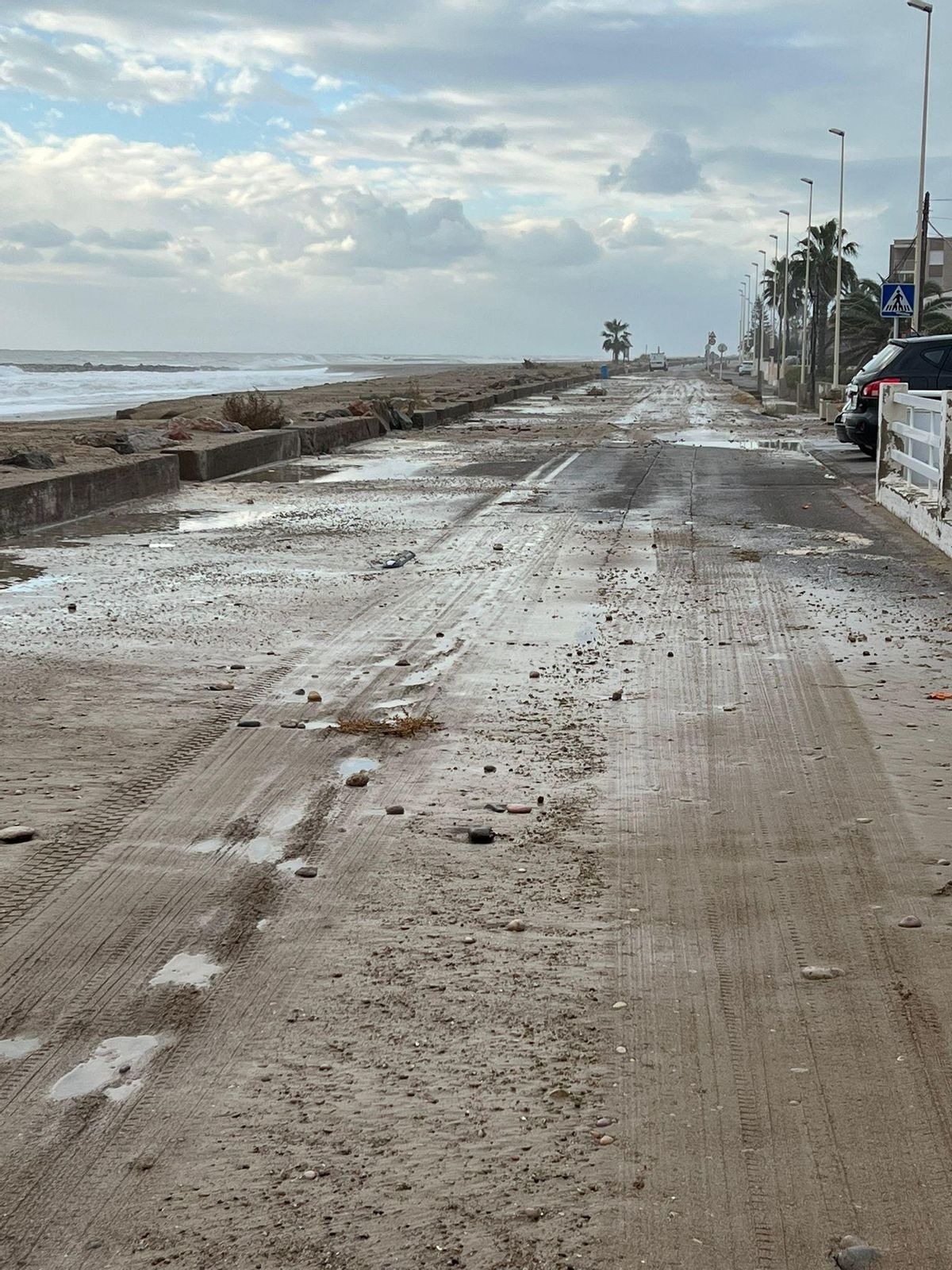 El oleaje arrastró arena y grava a la zona de la calzada en la playa de Almassora.