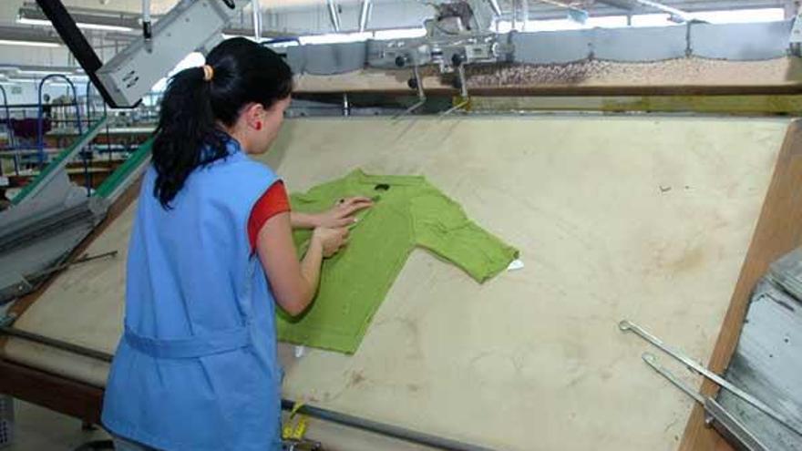 Una operaria manipula una prenda en la fábrica de Lalín.