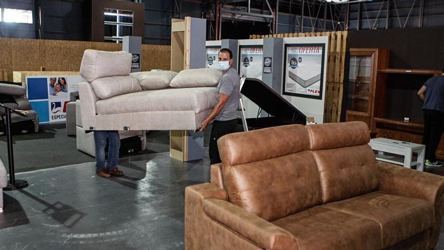 Trabajadores ultimando el salón del mueble en la feria.