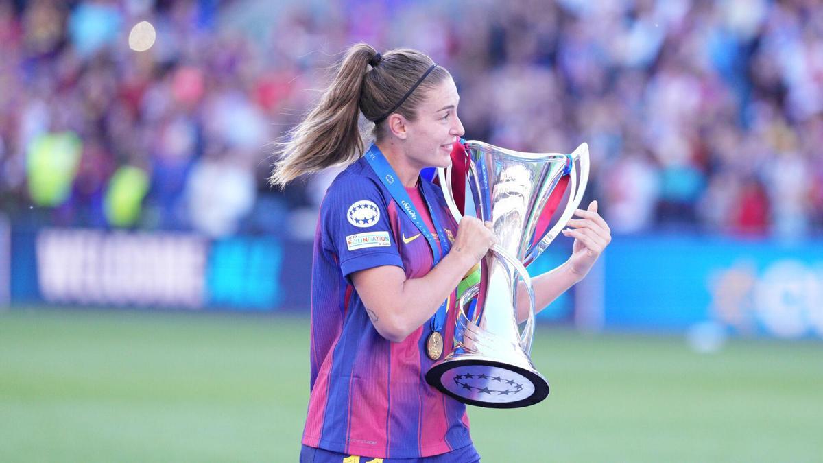 Alexia Putellas llevando el trofeo de la Champions a sus compañeras en Oslo