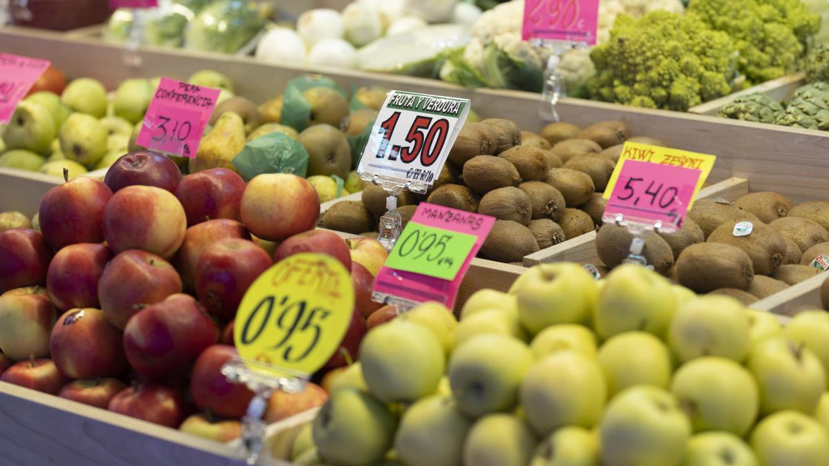 Manzanas y otras frutas en una frutería  en un puesto de un mercado.