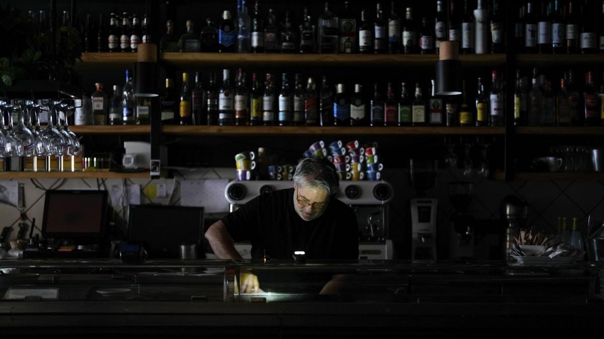Un hombre en el interior de un bar durante el apagón masivo en Madrid.