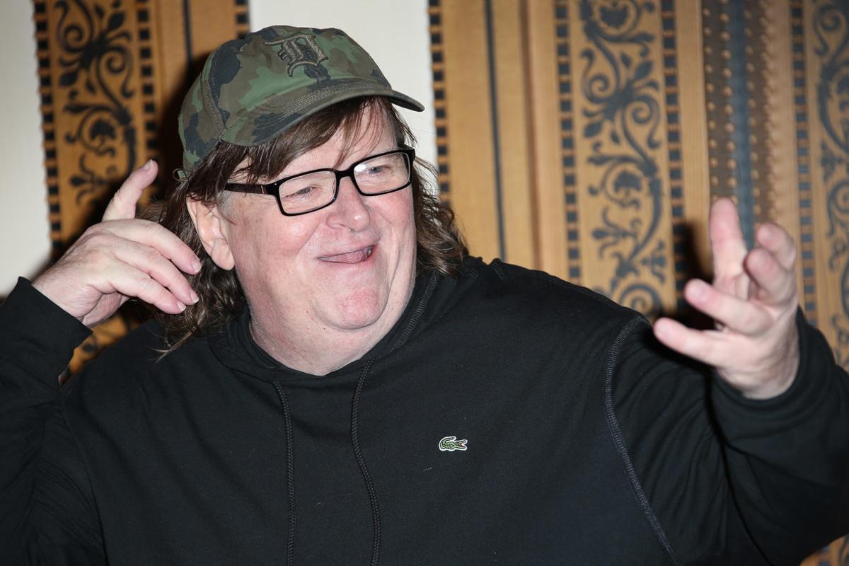 FILE - In this June 9, 2016, file photo, director Michael Moore reacts as he poses for photographers at the photo call of his new film, ’Where To Invade Next’ in London. Moore said during an online edition of HBO’s Real Time with Bill Maher in July 20, 2016, that he thinks Republican Donald Trump is going to win the upcoming presidential election. (Photo by Joel Ryan/Invision/AP, File)