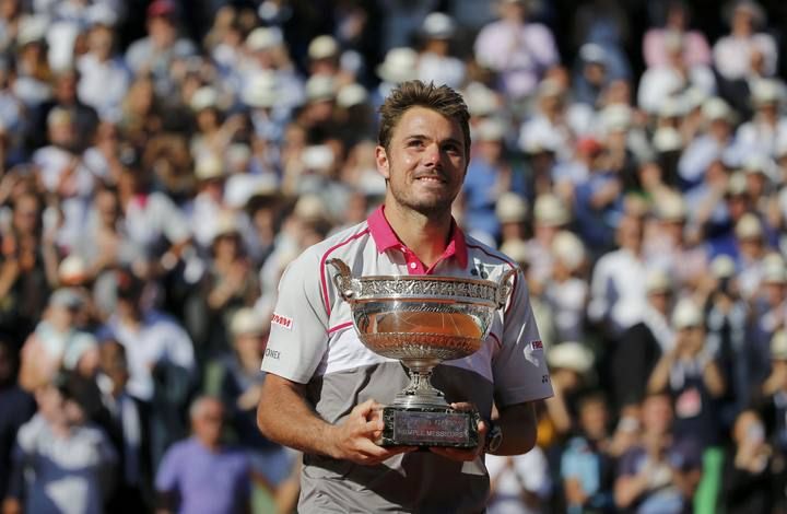 Stan Wawrinka of Switzerland poses with the trophy during the ceremony after winning the men's final match against Novak Djokovic of Serbia at the French Open tennis tournament at the Roland Garros stadium in Paris