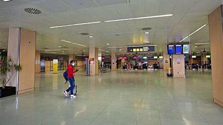 Un pasajero abandona la terminal del aeropuerto, prácticamente vacía a finales del mes de marzo.