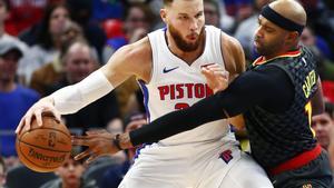 Atlanta Hawks forward Vince Carter  right  tries to steal the ball from Detroit Pistons forward Blake Griffin  left during the second half of an NBA basketball game  in Detroit   AP Photo Duane Burleson 