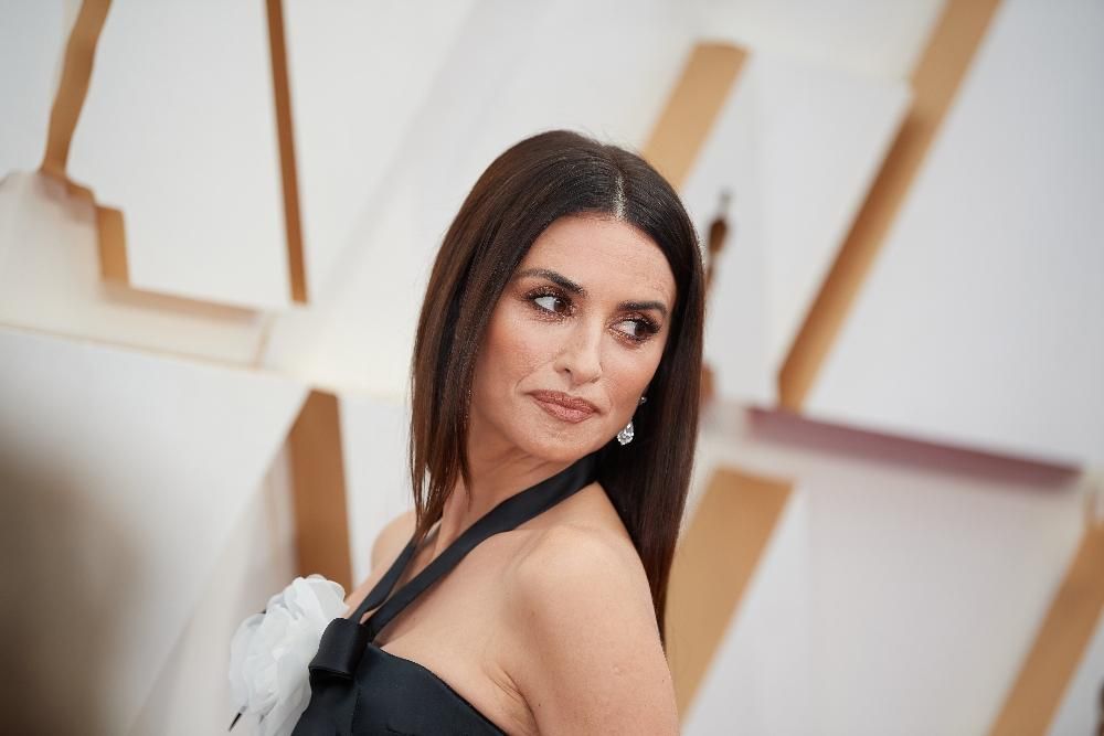 Penélope Cruz con el pelo suelto liso y con raya al medio
