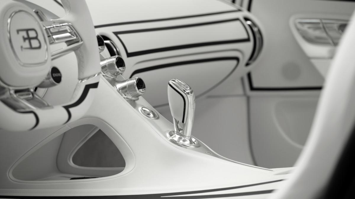 El habitáculo mantiene el mismo contraste exterior, con cuero blanco, trazos negros y una palanca revestida parcialmente en porcelana.