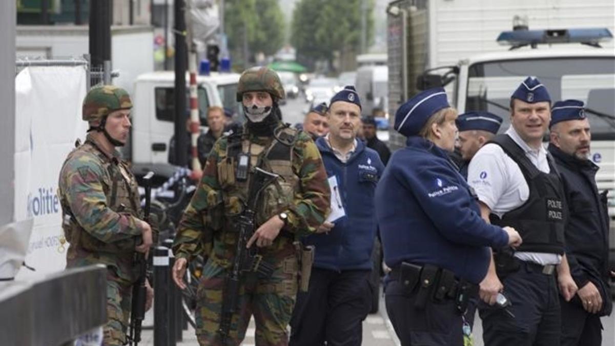 Un policía y un soldado belga vigilan la entrada a la zona evacuada por alerta de bomba este martes.