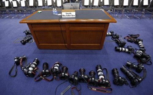 Cameras from news photographers surround a table before the arrival of U.S. Secretary of State Clinton on Capitol Hill in Washington