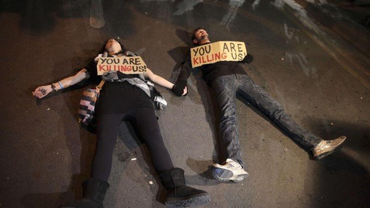 Chipriotas protestan contra la UE con el cartel 'Nos estás matando'.