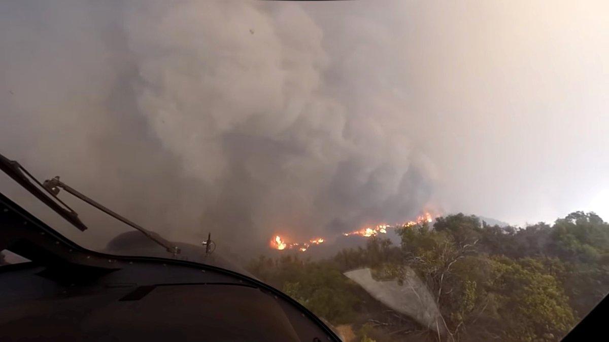 A helicopter takes off after a rescue made on the fly during the Woolsey Fire in Malibu  California  in this November 9  2018 still image taken from helmet camera footage by LAFD David Nordquist  LAFD David Nordquist Social Media via REUTERS       ATTENTION EDITORS - THIS PICTURE WAS PROVIDED BY A THIRD PARTY  NO RESALES  NO ARCHIVE  MANDATORY CREDIT