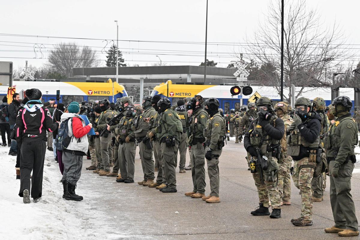 Protesters confront federal agents outside the Bishop Henry Whipple Federal Building, Thursday, Jan. 8, 2026, in Minneapolis, Minn. (AP Photo/Tom Baker)