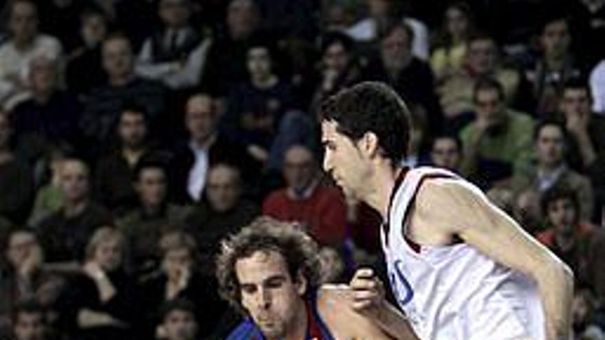 El escolta del Regal Barcelona, Roger Grimau ; avanza con el balón bajo la presión del también escolta del Tau Cerámica, Sergi Vidal ; durante el partido correspondiente a la decimosexta jornada de la Liga ACB que ambos equipos han disputado hoy en el Palau Blaugrana de Barcelona.