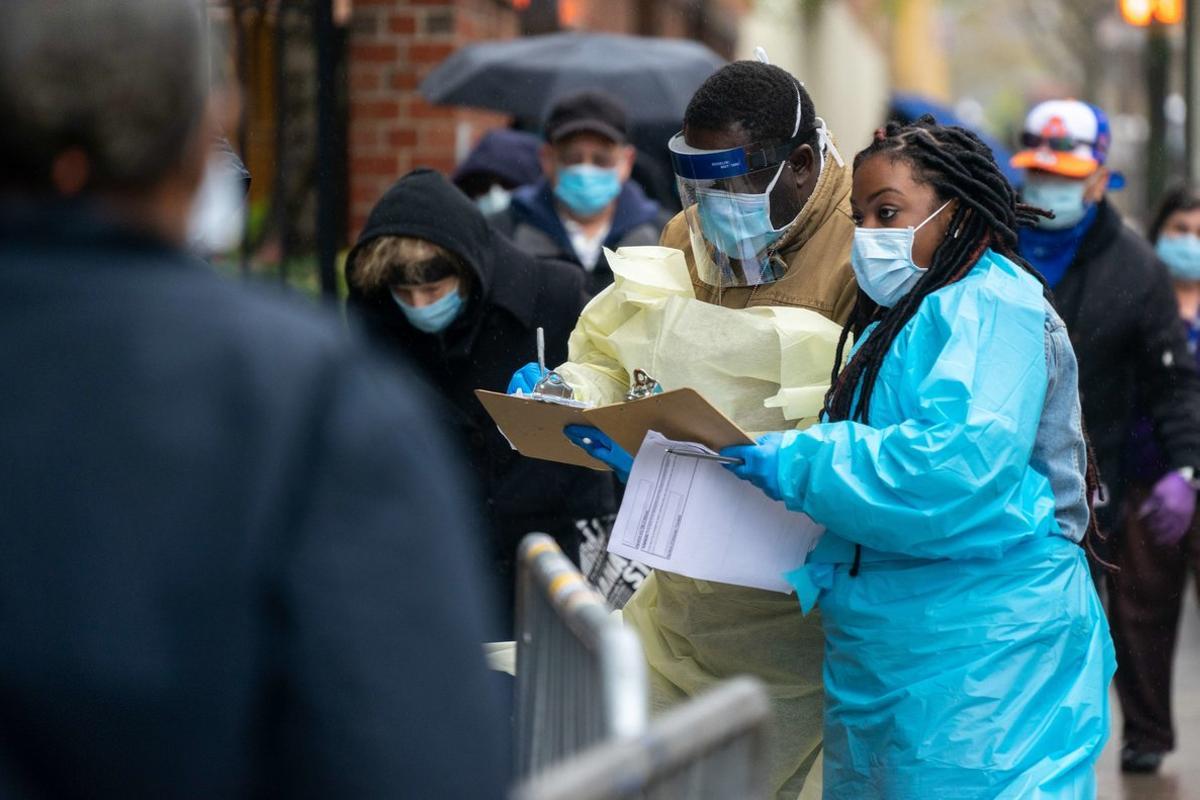 NEW YORK, NY - APRIL 24: Medical workers assist people standing in line at NYC Health + Hospitals/Gotham Health, Gouverneur waiting to be tested for the coronavirus (COVID-19) on April 24, 2020, in New York City. The NYC Health + Hospitals/Gotham Health, Gouverneur is one of the newest sites specifically for NYCHA city housing residents to open for diagnostic testing in some of the hardest-hit areas in New York City.   David Dee Delgado/Getty Images/AFP