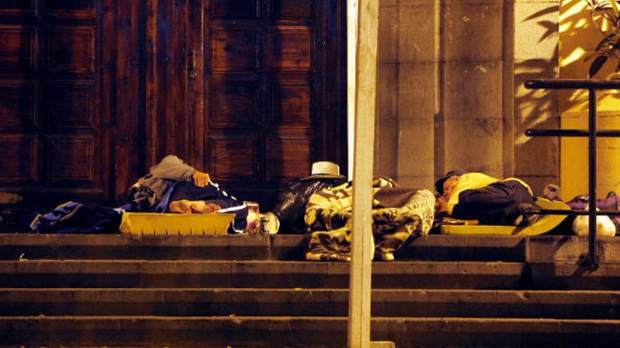 Varias personas duermen en la calle.