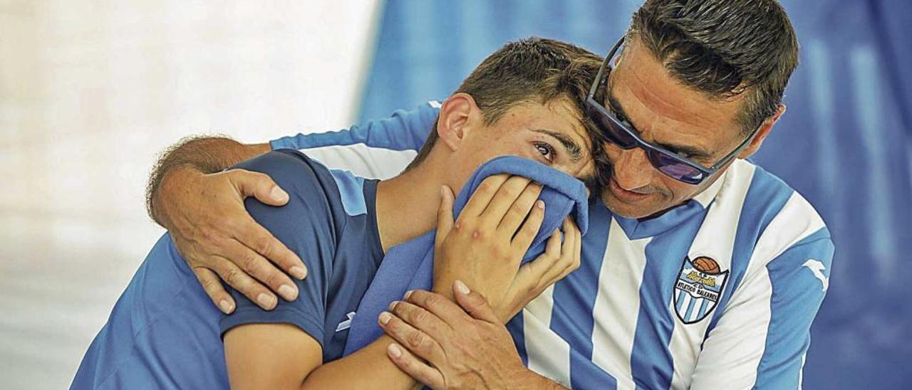 Un joven aficionado del Atlético Baleares es consolado al término del partido.