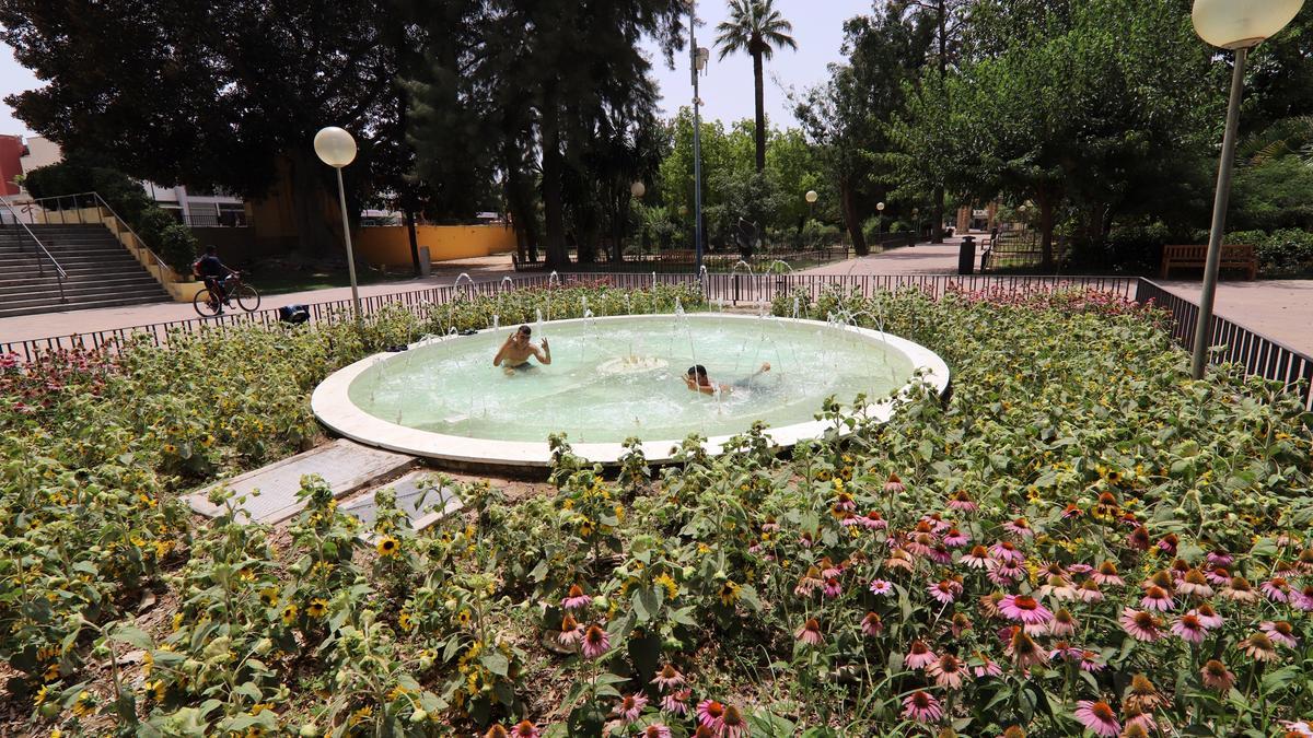 Dos jóvenes se bañan en una fuente del Malecón durante la pasada ola de calor.