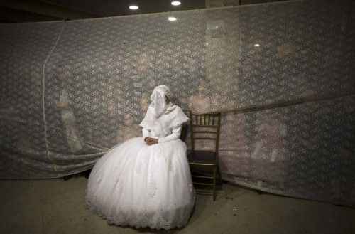 Ultra-orthodox Jewish bride watches her groom dance during their wedding ceremony in Jerusalem