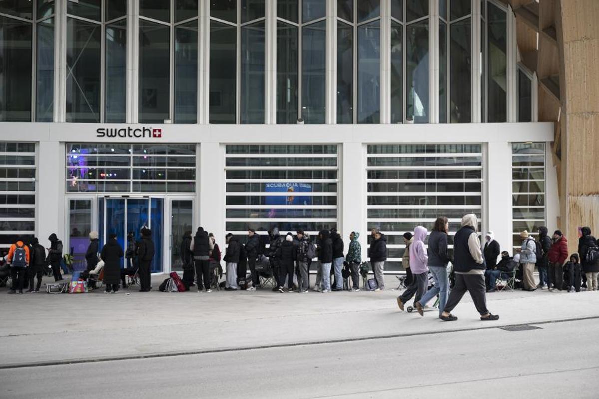 Personas esperan a que abra la tienda para comprar el nuevo reloj Royal Pop de Swatch y Audemars Piguet frente al Swatch Drive-Thru Store, junto a la sede de Swatch, en Biel/Bienne, Suiza.