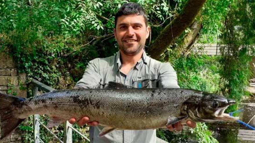 Salmón de mas de cuatro kilos y su pescador, junto al Mandeo.