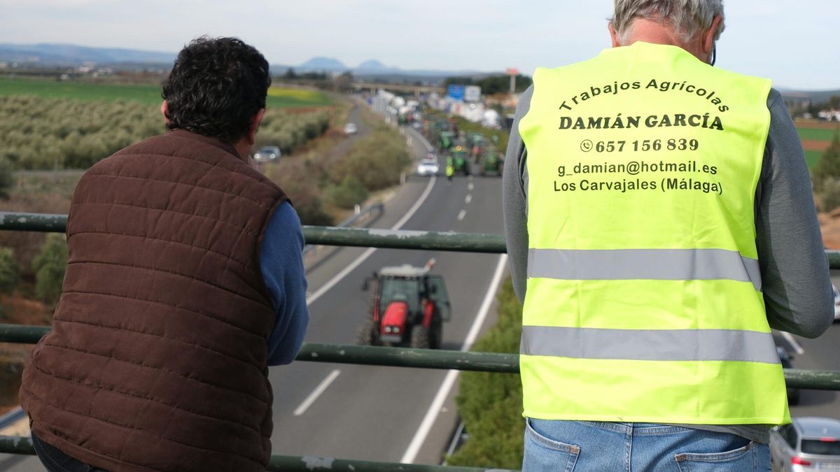 Dos agricultores observan la carretera durante la protesta de este miércoles.