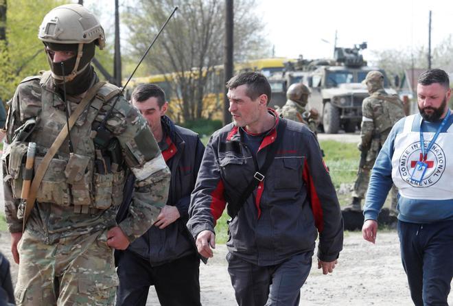 Civilians who left the area near Azovstal steel plant in Mariupol walk at a temporary accommodation centre in Bezimenne