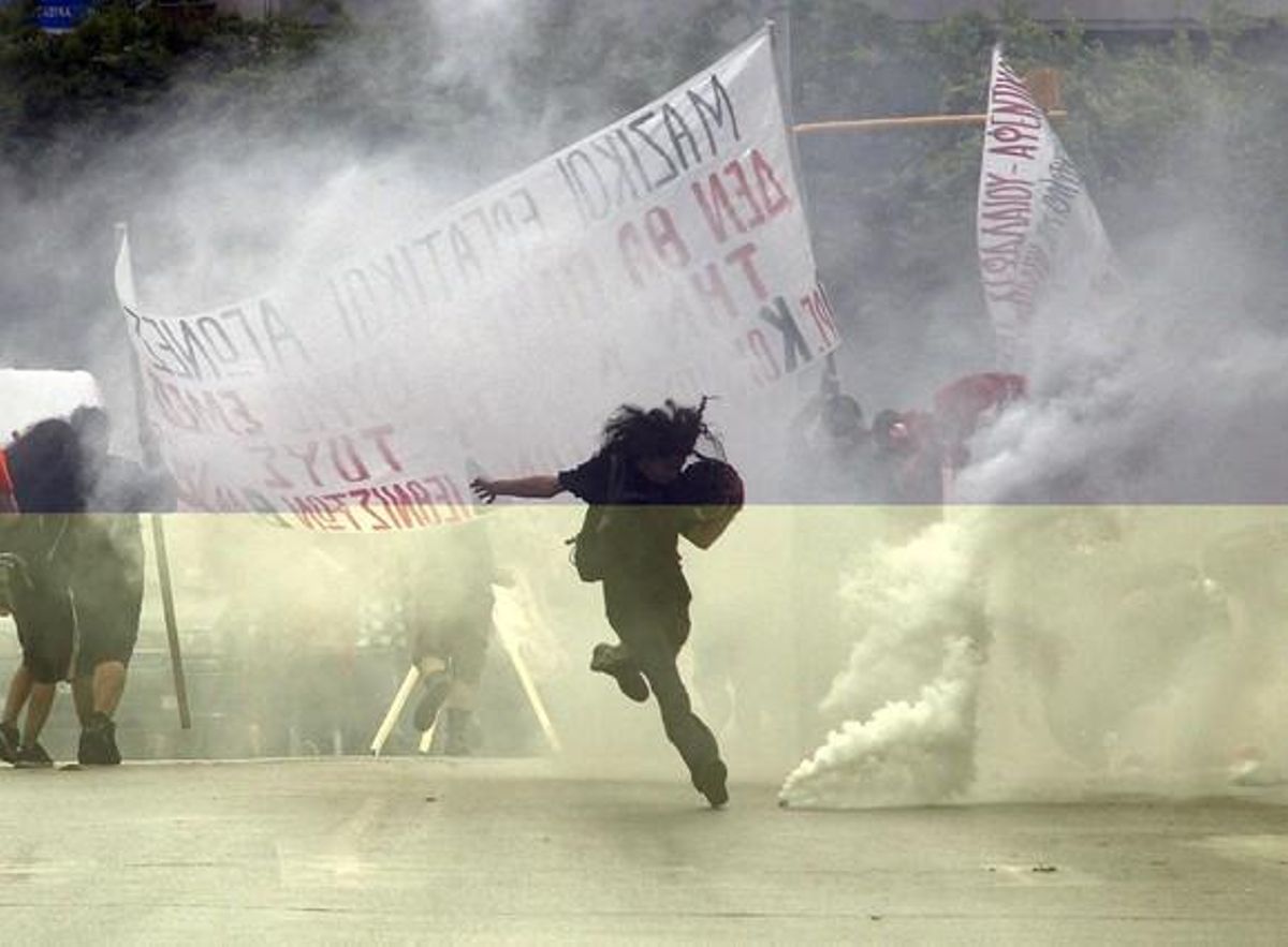 A protestor ikicks a teargas canister during violent demonstrations over austerity measures in Thessaloniki