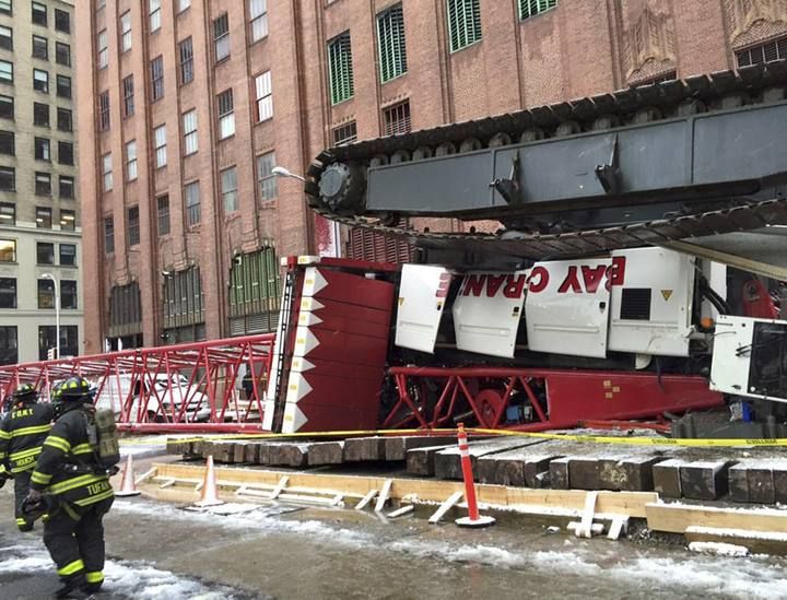 Emergency crews survey a massive construction crane collapse on a street in downtown Manhattan in New York