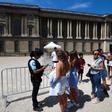 Una gendarme revista los códigos QR de turistas en la entrada de la zona gris frente al Museo del Louvre de París, este lunes.