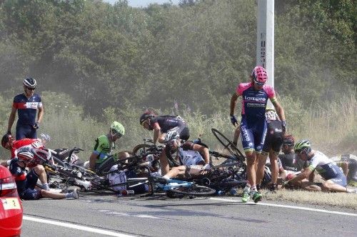 Riders and their bicycles fill the road after a fall during the third stage of the 102nd Tour de France cycling race from Anvers to Huy