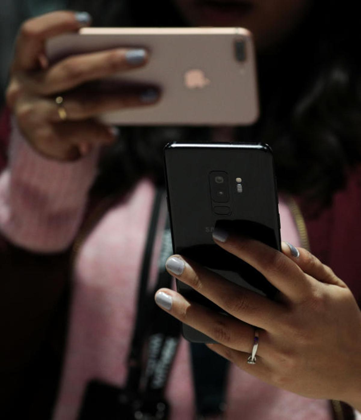 A woman takes a picture of Samsung's new S9 ...