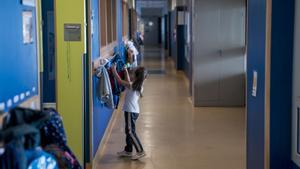 Archivo - Una niña cuelga su mochila en un perchero