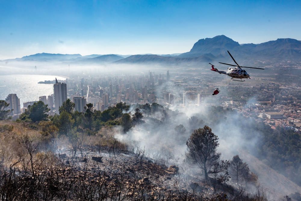 Los bomberos trabajan para sofocar un incendio en el parque de Serra Gelada