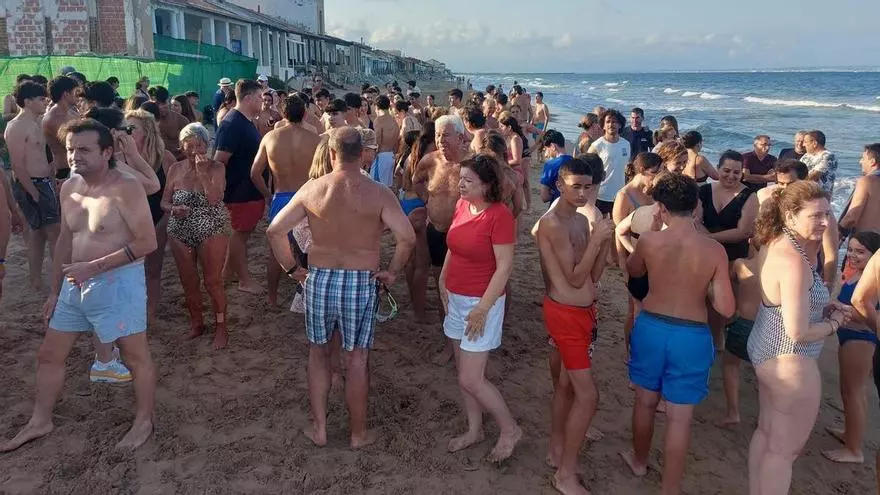 Vecinos de Babilonia se concentran para reivindicar que se mantengan en pie las casas con un chapuzón reivindicativo en Guardamar