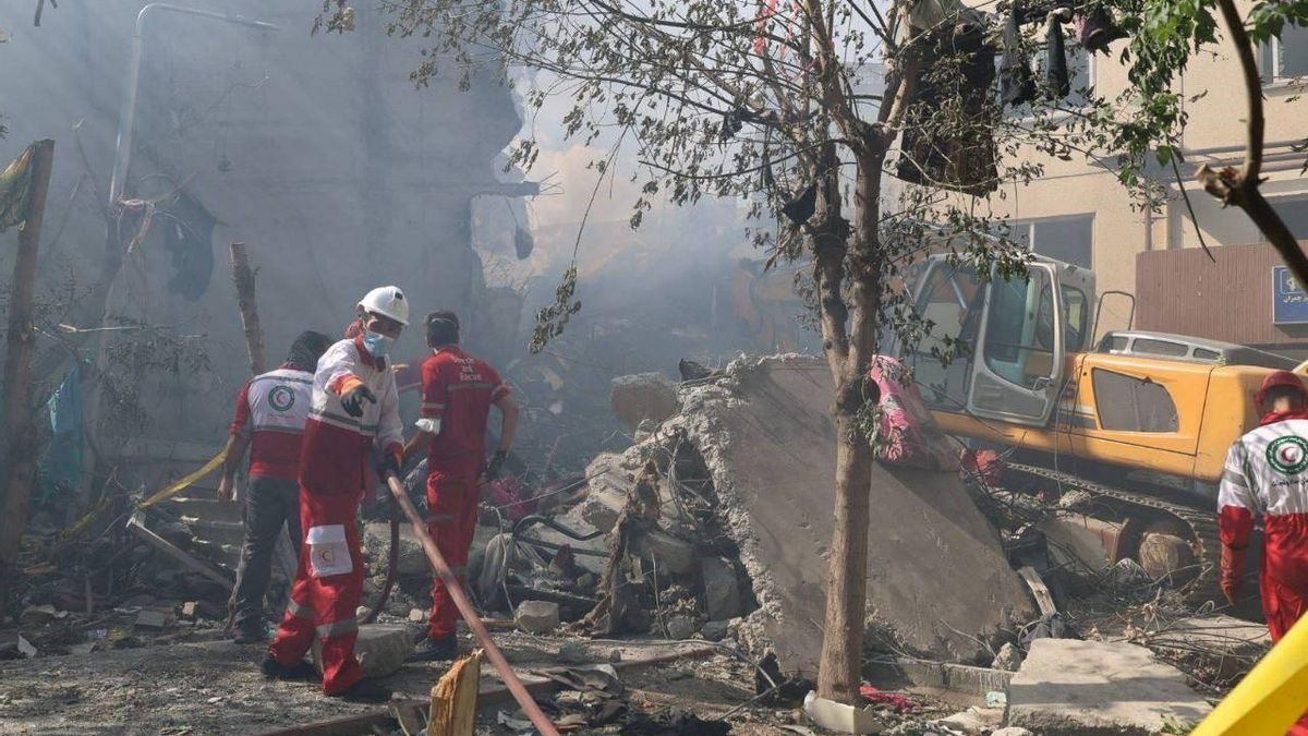 Equipos de emergencias junto a un edificio dañado por los bombardeos de Israel en Teherán.