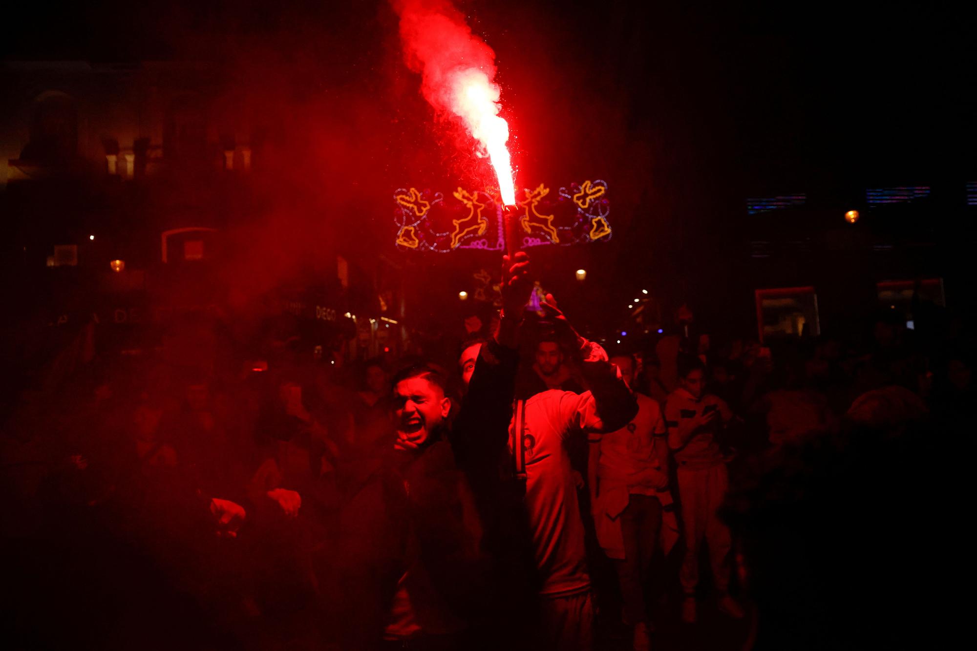 Morocco fans celebrate as they gather in Sol square after the FIFA World Cup Qatar 2022 match between Spain and Morocco, in Madrid