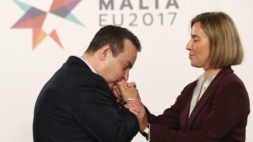 El ministro serbio de Exteriores, Ivica Dacic, besa a Mogherini. // Efe