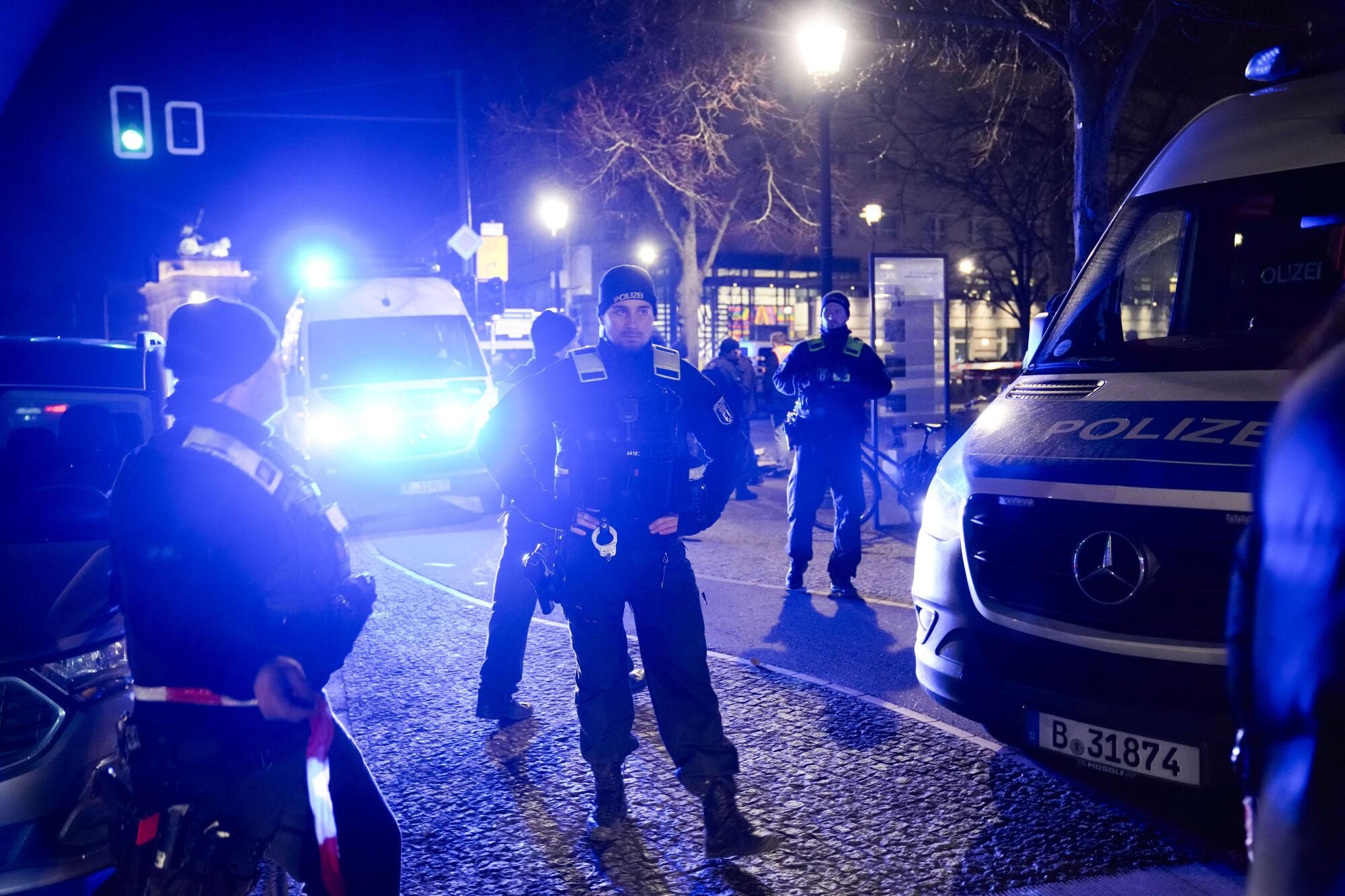 Police officers attend the scene at the Holocaust memorial after a man was attacked at the memorial site in Berlin, Germany, Friday, Feb. 21, 2025. (AP Photo/Ebrahim Noroozi)
