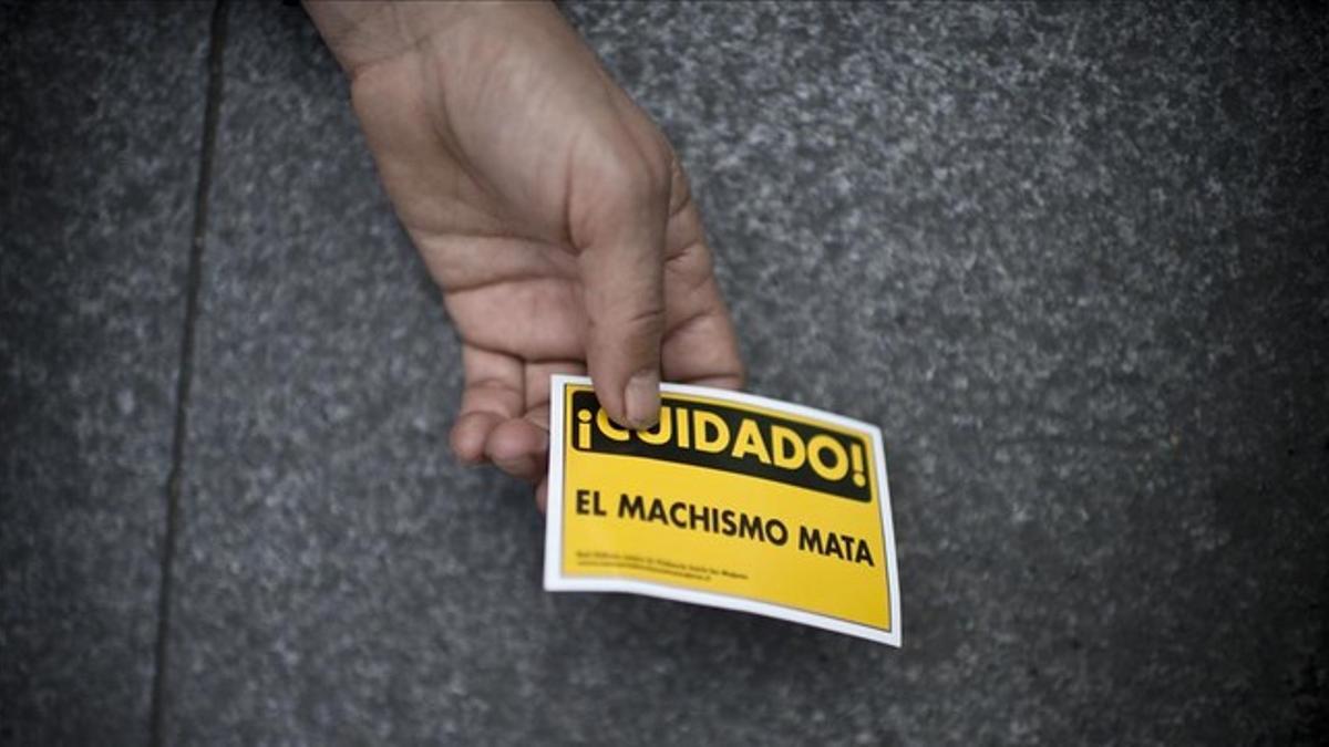Una mujer sostiene un cartel de advertencia contra la violencia machista, en Buenos Aires