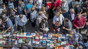 Un Sant Jordi lleno de libros y gente en Las Ramblas.