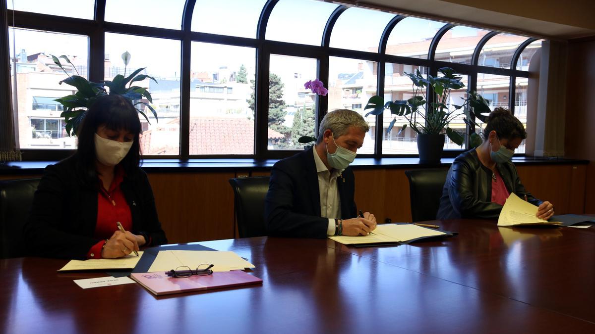 La presidenta de l&#039;FMC, Olga Arnau; el conseller d&#039;Educació, Josep Gonzàlez-Cambray; i la vicepresidenta de l&#039;AMC, Mercè Bosch, signant l&#039;acord