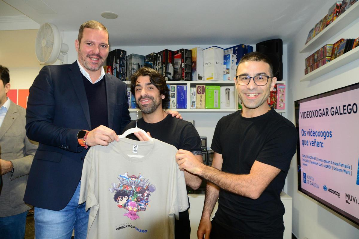 El conselleiro (izda.) recibió como regalo una camiseta de Videoxogo Galego