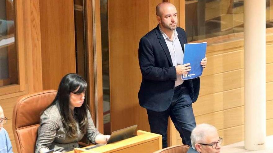 Villares, pasa ante Paula Quinteiro durante un pleno del Parlamento.